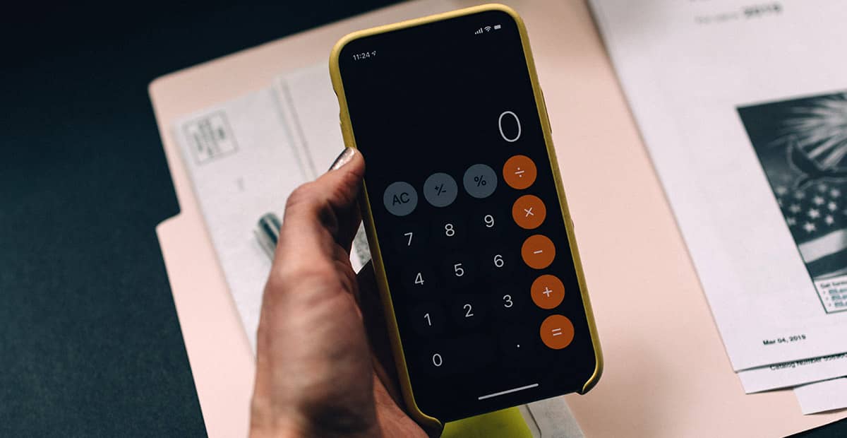 person holding phone with calculator app